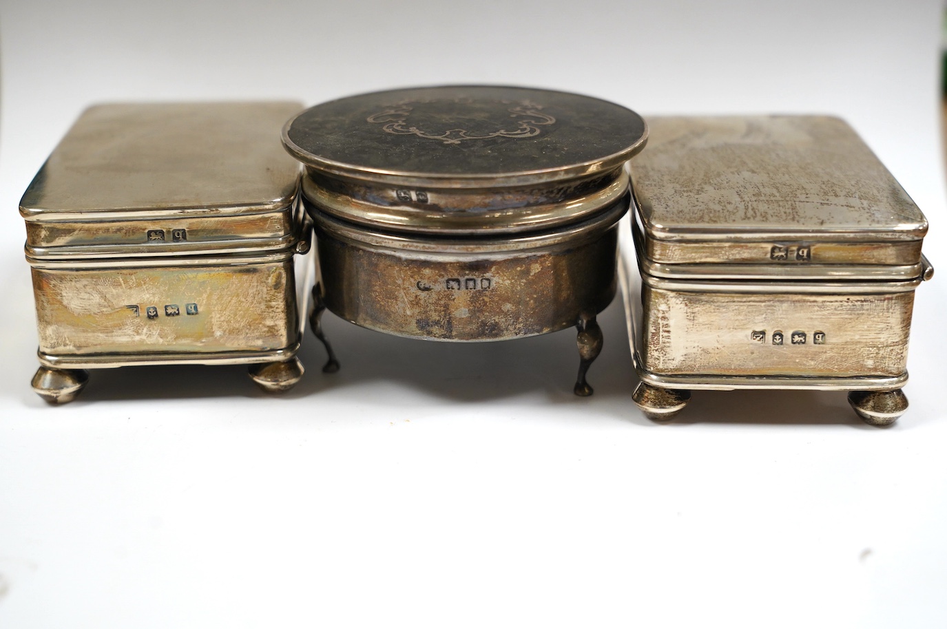 Two late Victorian repousse silver trinket boxes, largest 13.3cm, a pair of George V silver trinket boxes and a tortoiseshell and silver mounted circular trinket box. Condition - poor to fair